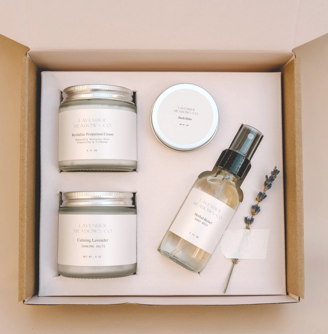 Set of skincare products including a candle, cream, and spray bottle in a box.