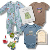 Collection of baby clothing and items with fishing theme on a white background