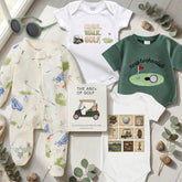 Collection of children's clothing and a book titled 'The ABCs of Golf' on a light wooden surface with greenery.