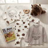 Children's clothing and toys including a onesie with bison design, a baby bison plush toy, and a book titled 'B is for Bison'.