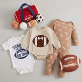 Collection of baby clothing and sports-themed items on a gray background