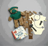 Doctor-themed baby gift set with teddy bear, onesie, toy stethoscope, and 'My Doctor's Visit' book