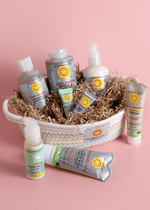 Collection of Sun Bum skincare products in a basket on a pink background