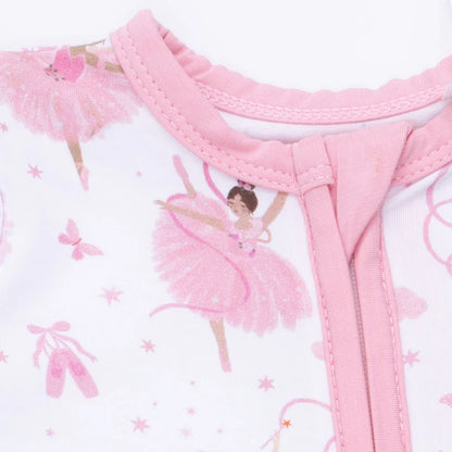 Close-up of a baby outfit with pink ballerina design on a white background