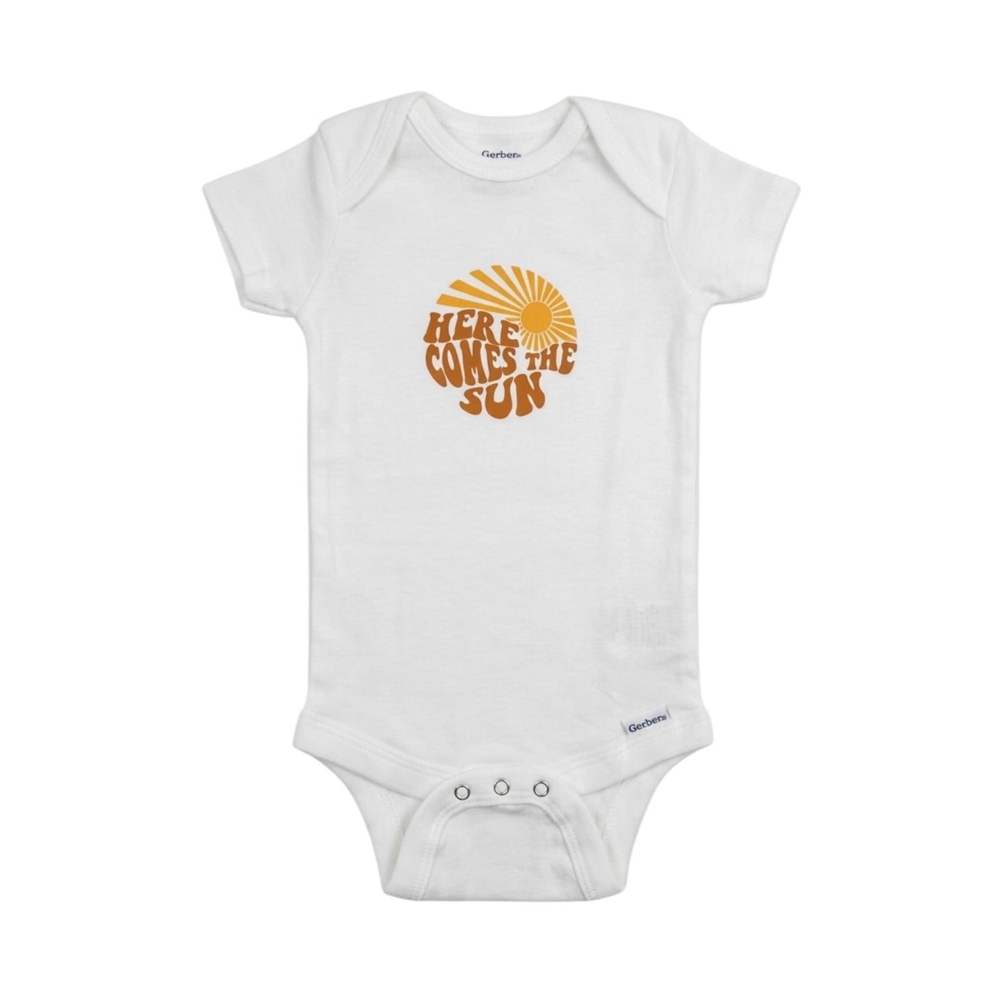 White baby onesie with 'Here Comes the Sun' text and sun graphic on a white background