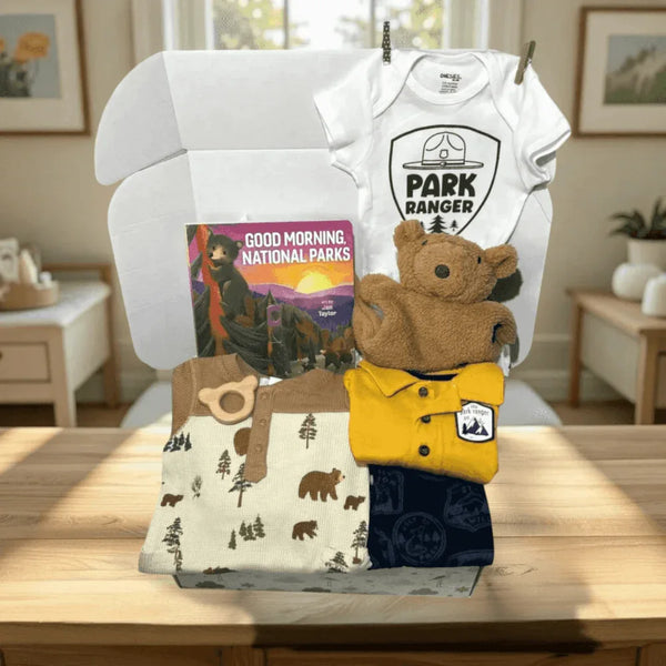 Collection of children's clothing and items on a chair in a room with a window and decor.