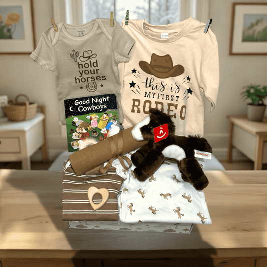 Collection of baby-themed clothing and toys on a table with a home interior background.