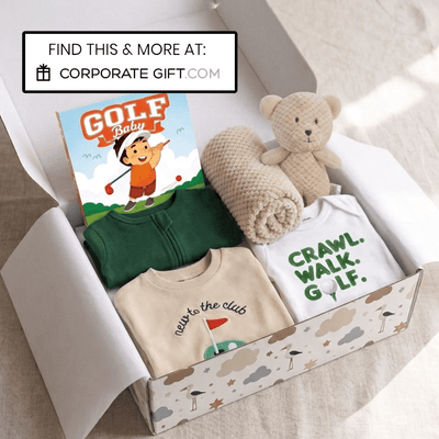 A baby golf-themed gift box containing a green baby zip-up shirt, a cream t-shirt with 'CRAWL. WALK.