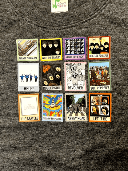 Collection of The Beatles album covers on a dark fabric background