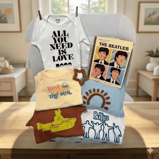 Collection of baby clothing and Beatles-themed items on a table.