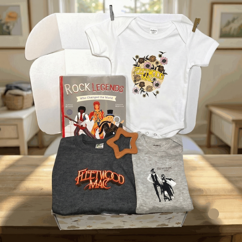Collection of clothing and a book on a table with a neutral background