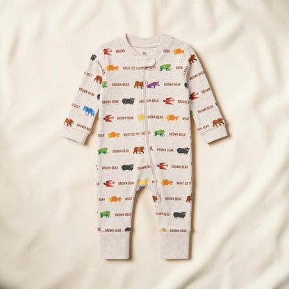 A baby long-sleeve footless one-piece romper in a light cream color, featuring an all-over print of colorful cartoon bears and the text 'BROWN BEAR' and 'WHAT DO YOU SEE?'. The romper is laid flat on a soft, textured off-white fabric background.