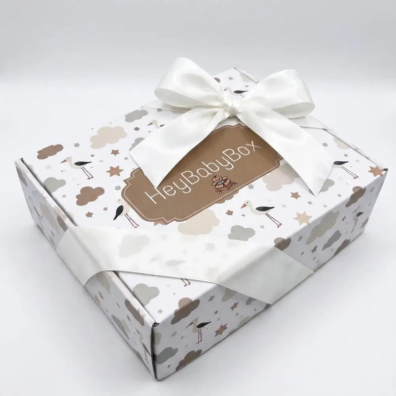 Gift box with 'HeyBabyBox' branding and decorative elements on a white background