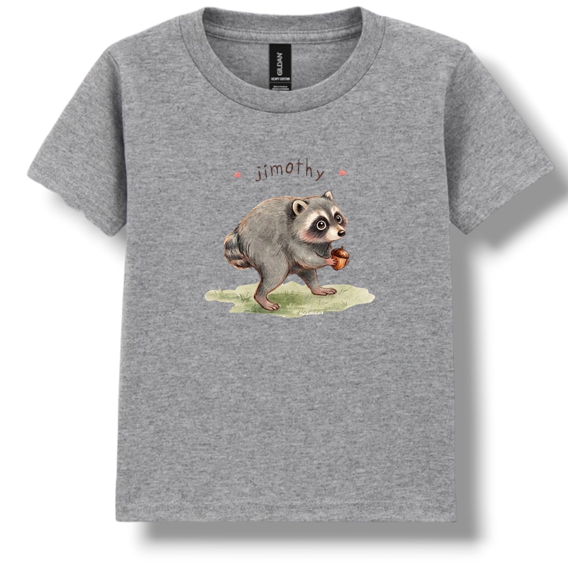 A heather gray short-sleeve crewneck t-shirt featuring a watercolor-style graphic of a raccoon holding an acorn with the name 'jimothy' printed above it, displayed on a clean white background.