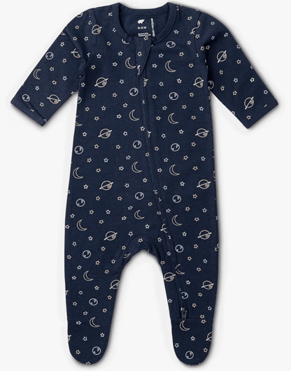 A baby long-sleeve footless one-piece jumpsuit in navy blue with a white celestial print of stars, moons, and planets, shown on a mobile phone shopping screen.
