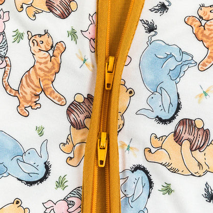 Close-up of a yellow zipper on a fabric with cartoon animal patterns.