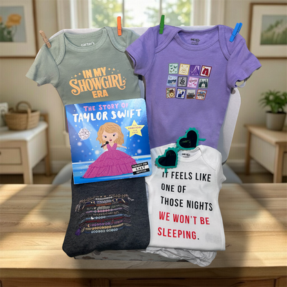 Collection of baby clothes and a book on a table with a home setting in the background