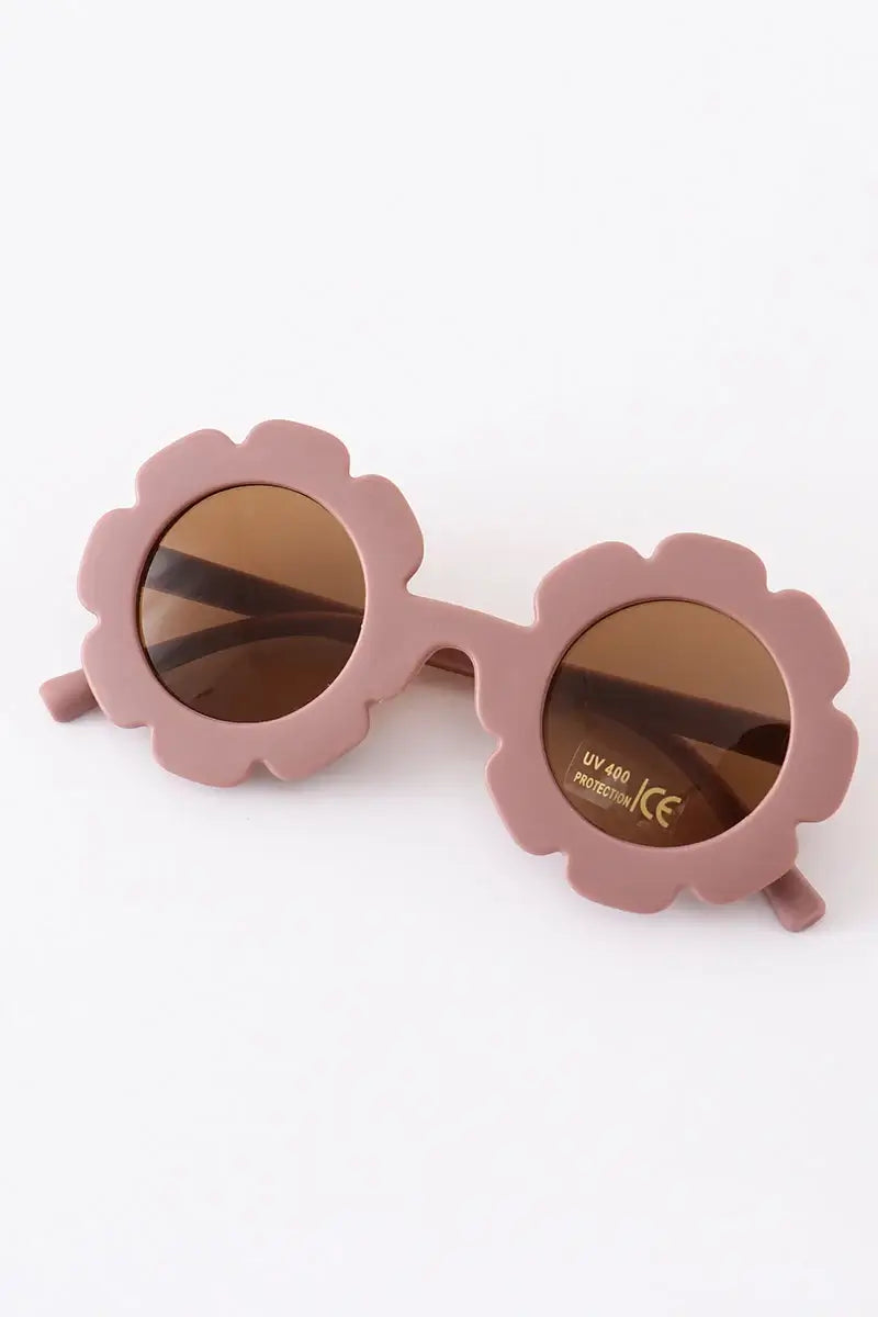 Pink sunglasses with floral-shaped frames on a white background