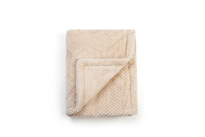 Beige blanket with textured surface on a white background