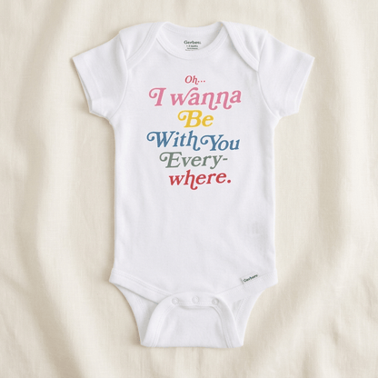 A white short-sleeve baby bodysuit with colorful text reading 'Oh.