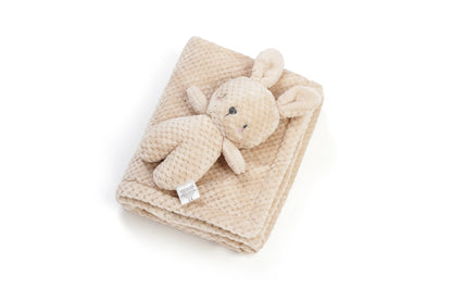 A beige textured waffle-knit baby blanket with a matching plush bunny stuffed animal, photographed on a clean white background.