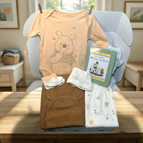 Winnie the Pooh clothing set with a bear design on a chair in a room.