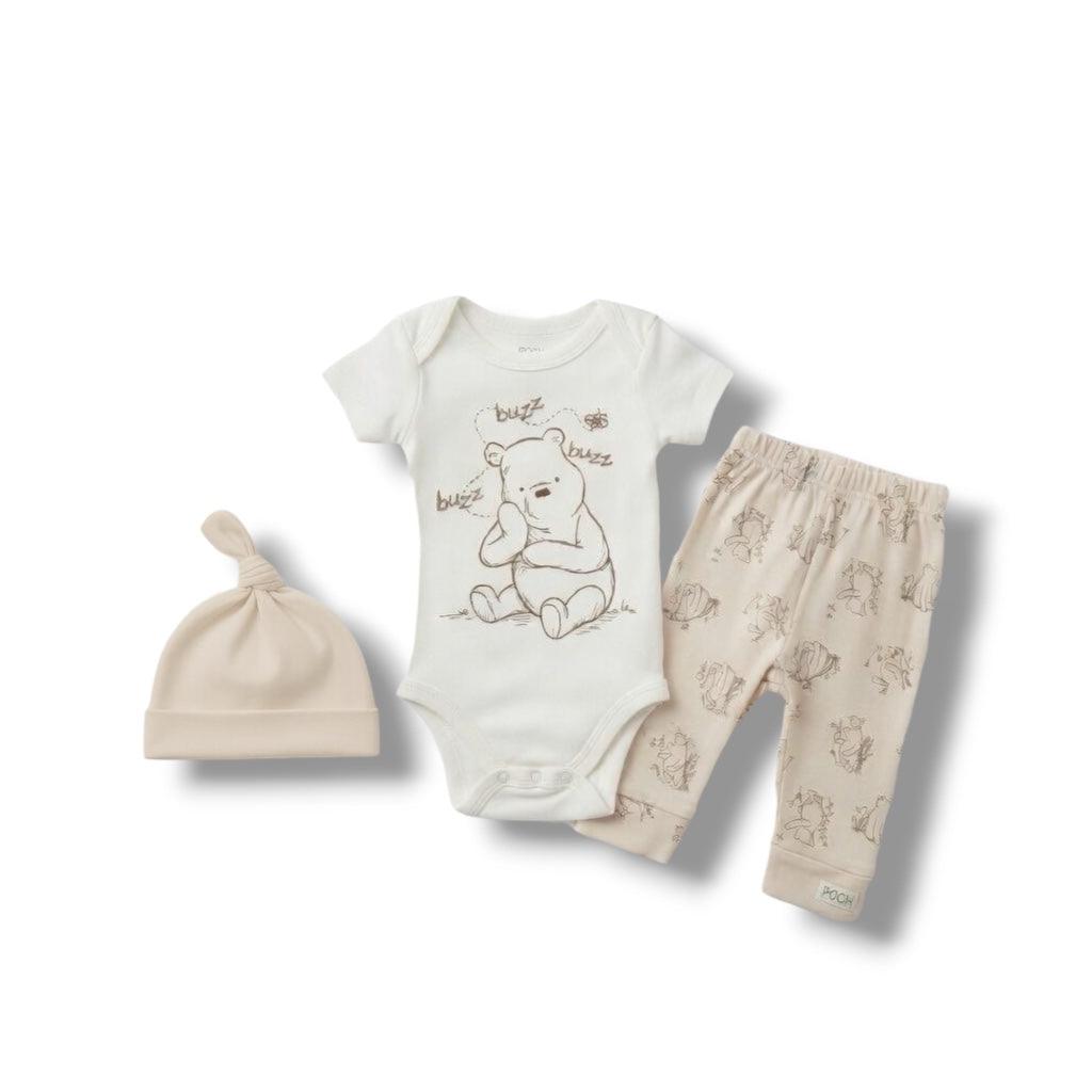 Baby outfit set with onesie, pants, and hat on a white background