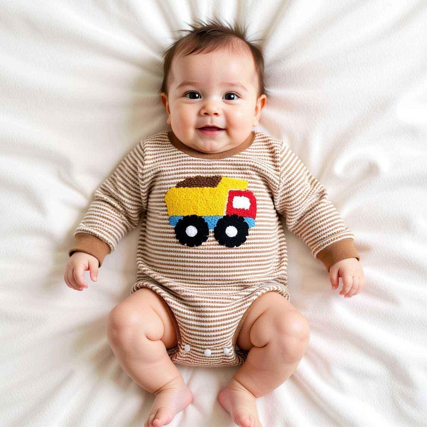 Baby in striped onesie with colorful truck design, perfect for baby showers and themed gifts