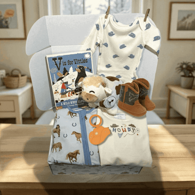 Baby clothing and toys on a chair with a book titled 'V is for Vittles'.
