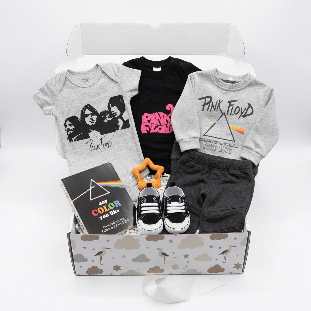 A curated gift box set for kids featuring a gray band t-shirt, a black Pink Floyd t-shirt, a gray sweatshirt with a Pink Floyd prism graphic, black shorts, black and white sneakers, a book, and a star-shaped rattle inside a cloud-patterned box.