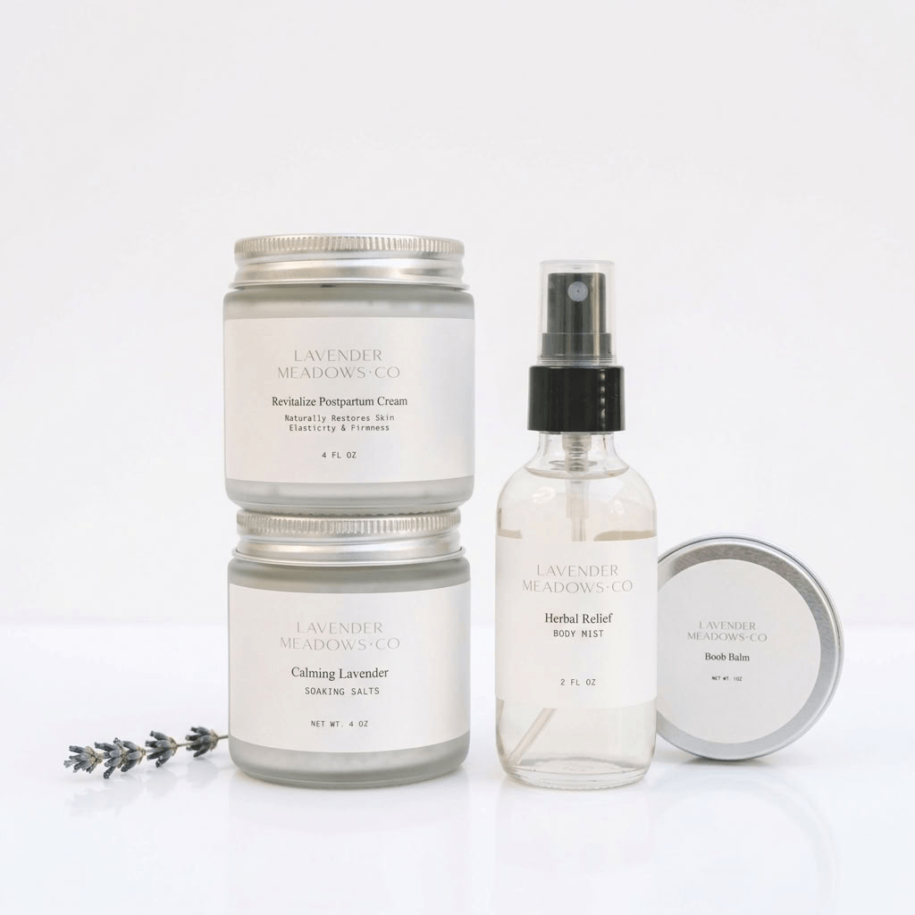 Lavender Meadows Co. bath and body set featuring two lavender body butter jars, a herbal relief rose melt spray bottle, and a bath bomb tin, arranged on a clean white background with a sprig of lavender.