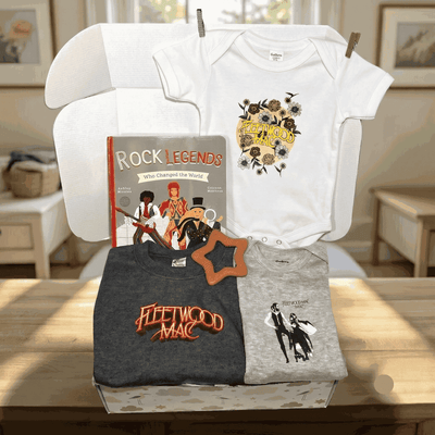 Collection of clothing and a book on a table with a neutral background