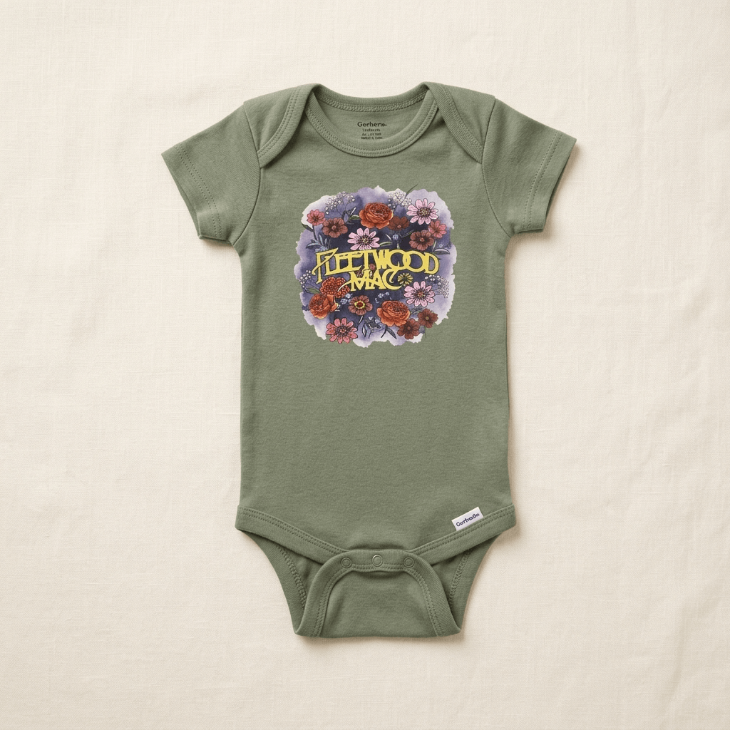 An infant short-sleeve bodysuit in sage green, featuring a 'Fleetwood Mac' floral graphic on the chest, laid flat on a textured off-white fabric background.