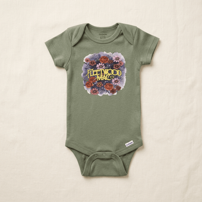 An infant short-sleeve bodysuit in sage green, featuring a 'Fleetwood Mac' floral graphic on the chest, laid flat on a textured off-white fabric background.