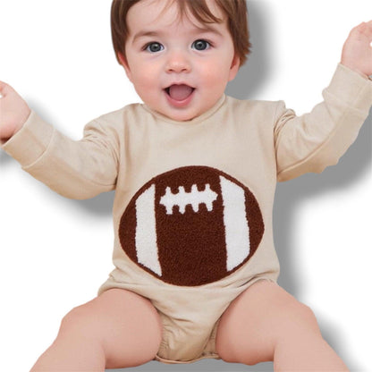 Baby wearing a beige onesie with a football design on a white background