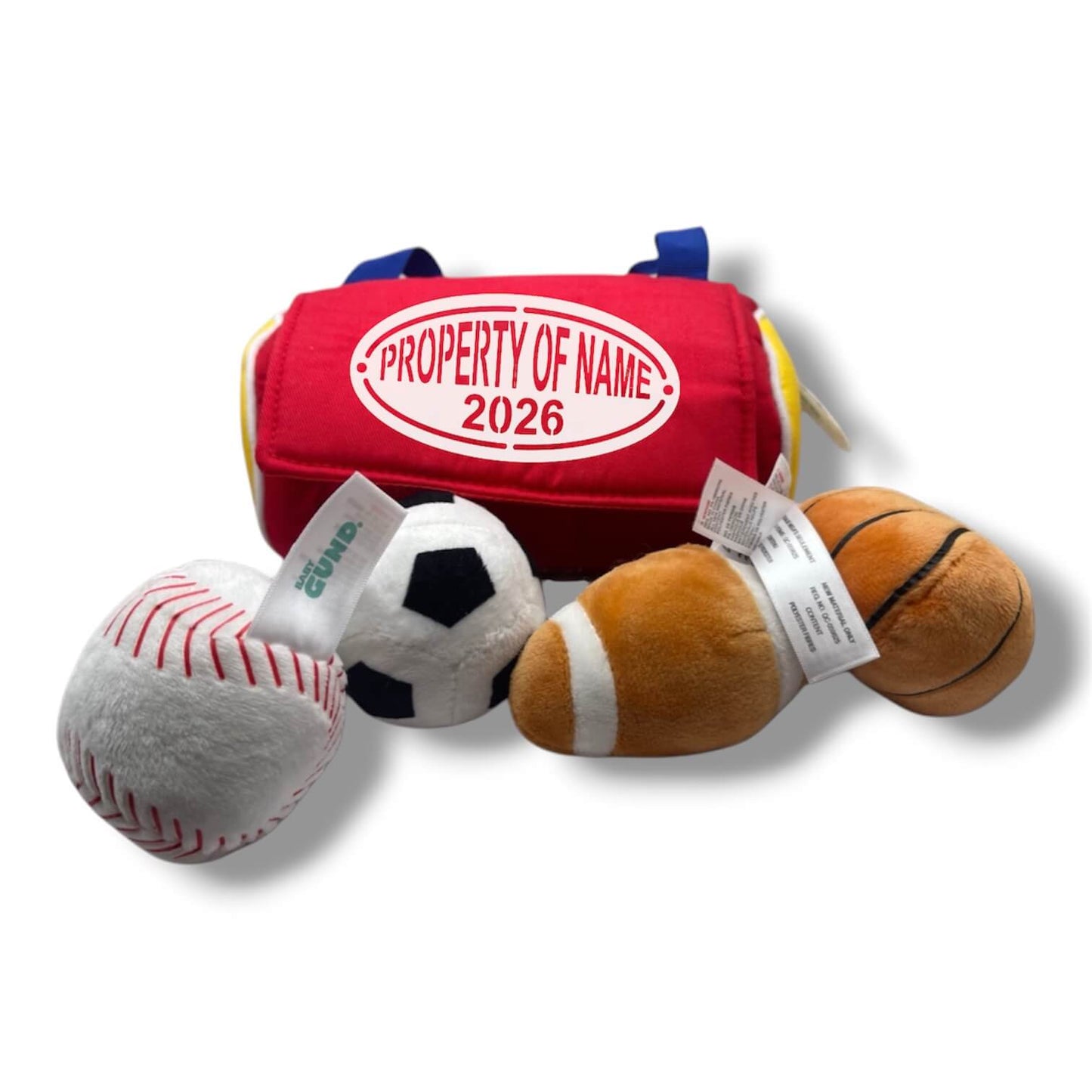 Set of plush sports balls and a red bag labeled 'PROPERTY OF NAME 2026' on a white background