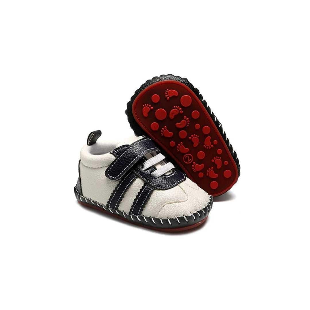 Hey Baby Box white and navy leather baby shoes with velcro straps and red footprint sole.