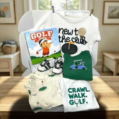 Hey Baby Box Golf Theme Baby Gift Set: white sweater, green onesie with golf cart, cream polo romper, white onesie with 'Crawl Walk Golf', baby golf shoes, and 'Golf Baby' book.