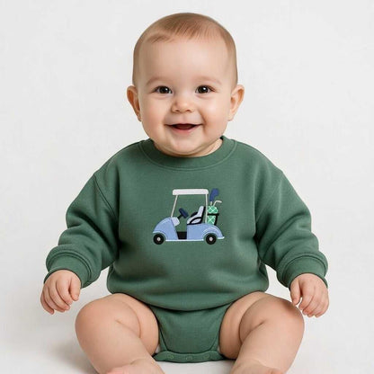 Baby wearing a green long-sleeved bodysuit with a blue golf cart embroidered on the front. The golf cart has golf clubs in the back.