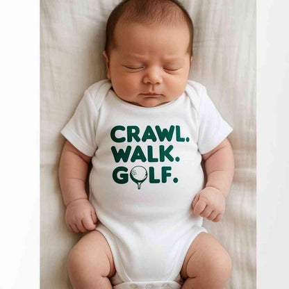 Hey Baby Box white cotton baby onesie with green text "Crawl. Walk. Golf." and a golf ball on a tee graphic.