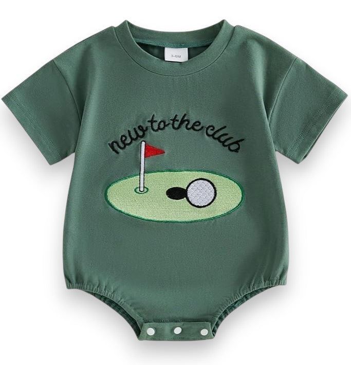 Green baby romper with golf design and text 'new to the club' on a white background