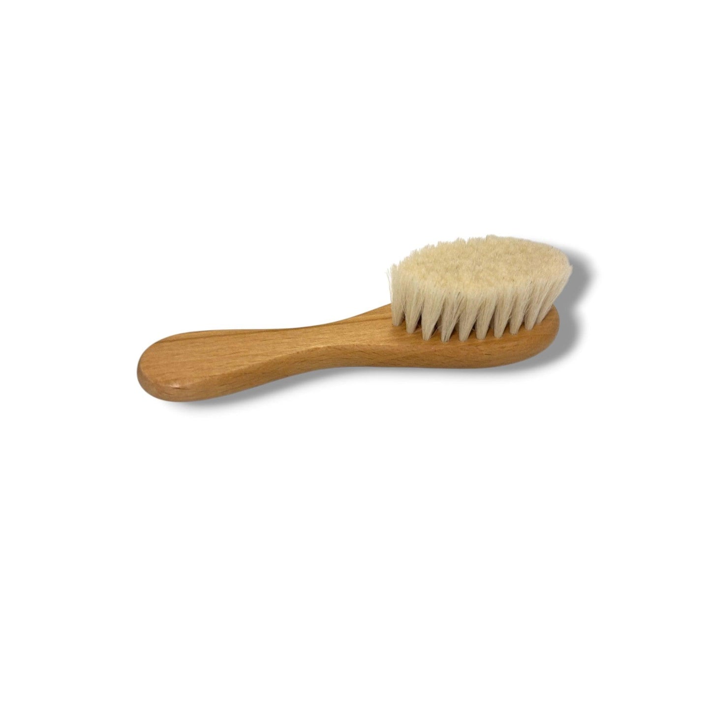 Wooden brush with bristles on a white background