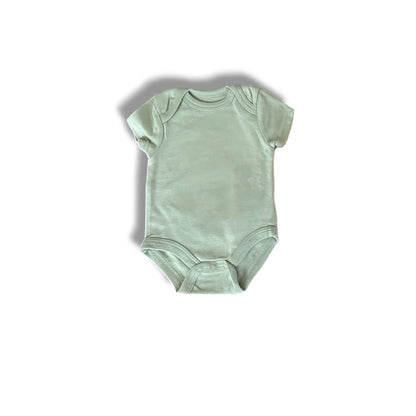 Mint green baby onesie on a white background
