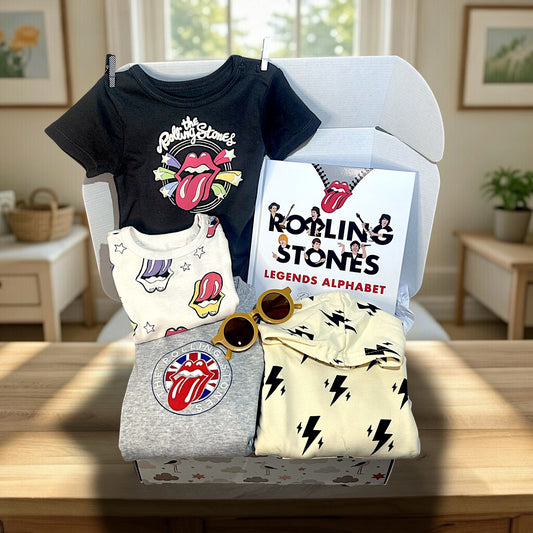 Hey Baby Box Rolling Stones inspired baby gift set with black, white, and grey onesies, a book, and sunglasses.