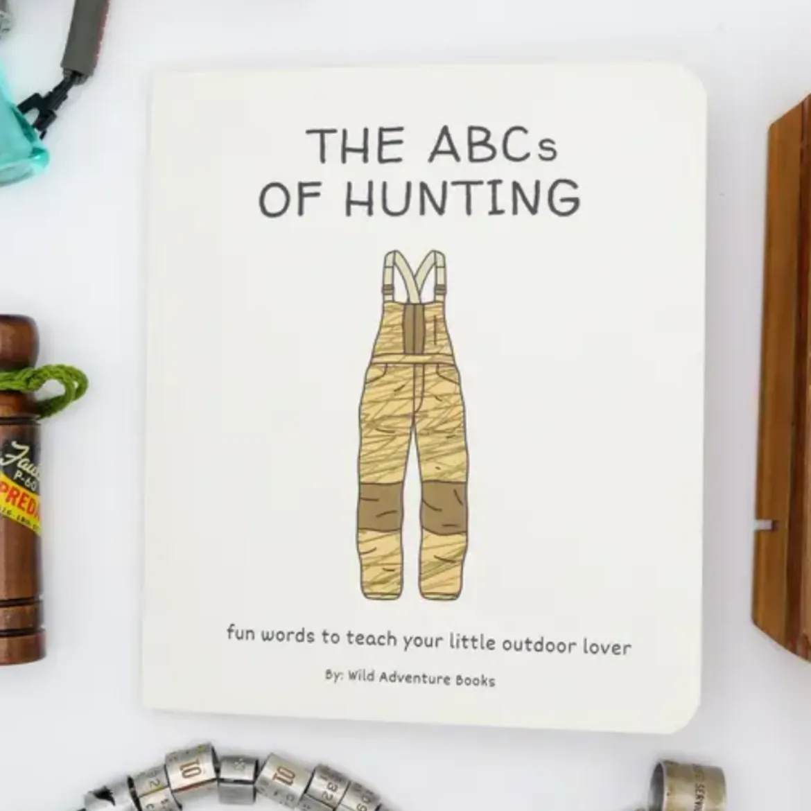 Book titled 'The ABCs of Hunting' on a white surface with hunting-themed items.