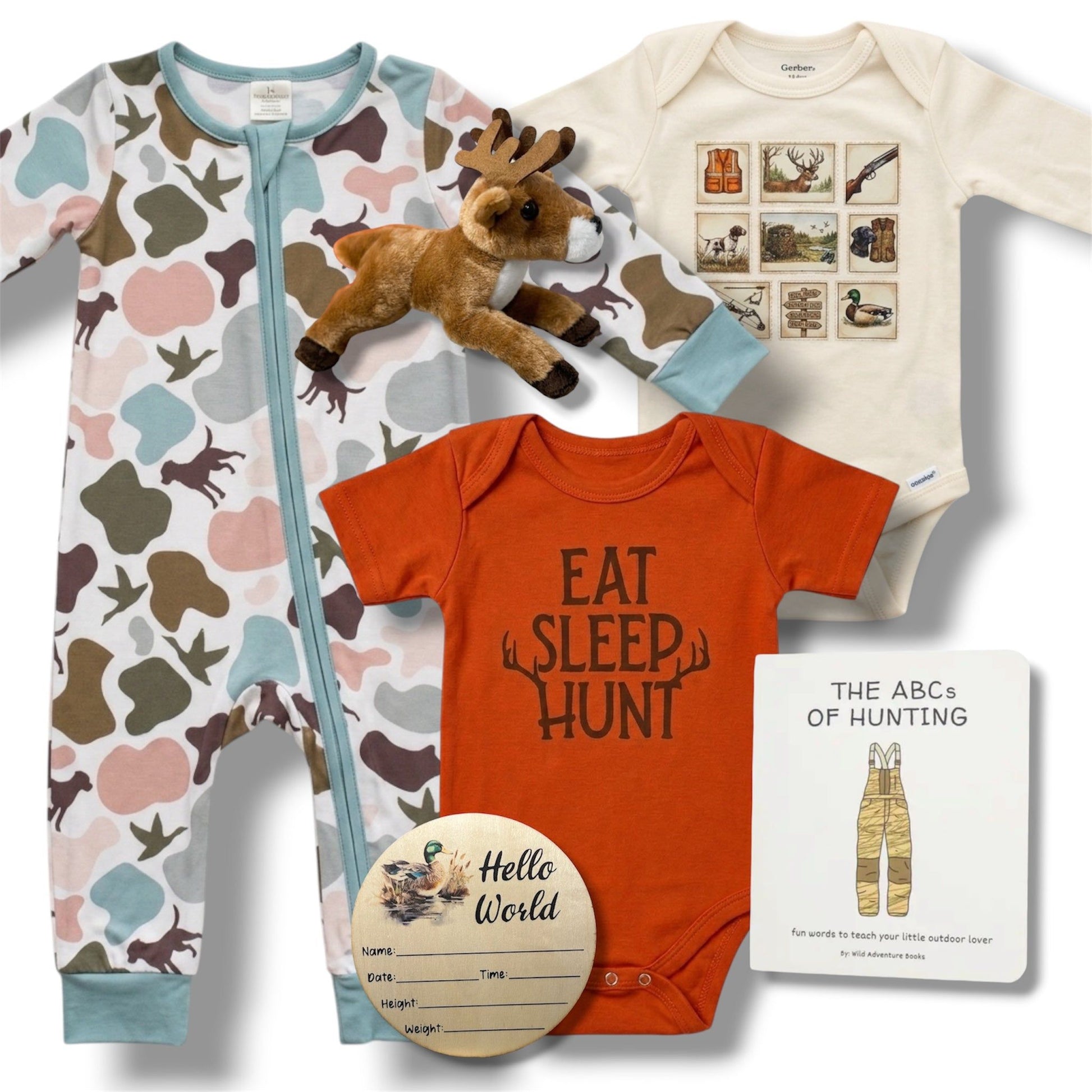 Collection of baby clothing and toys including a onesie with 'Eat Sleep Hunt' text, a plush deer, and a book on a white background.