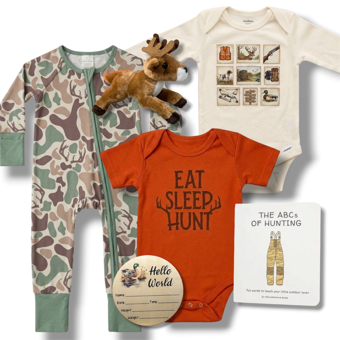 Collection of baby clothing and toys including a onesie, romper, and stuffed animal on a white background.