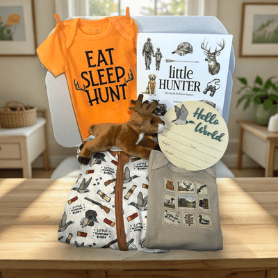 Baby gift set with 'Eat Sleep Hunt' shirt, baby blanket, and other items on a wooden surface.