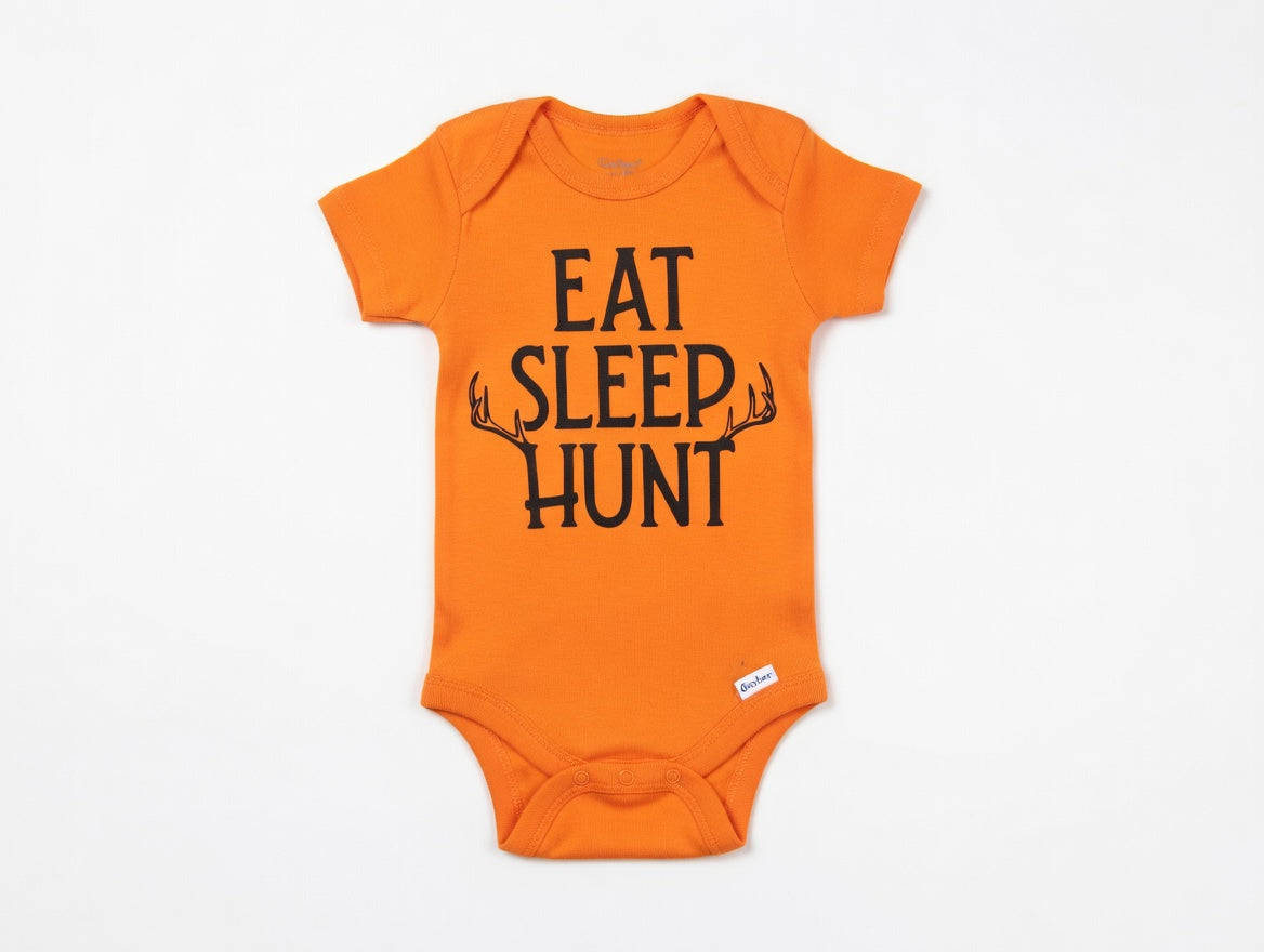Orange baby onesie with 'EAT SLEEP HUNT' text on a white background