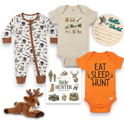Collection of baby clothing and items with hunting-themed designs on a white background